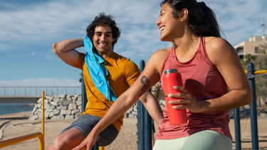 Protein powders and vitamins laid out for summer fitness routine